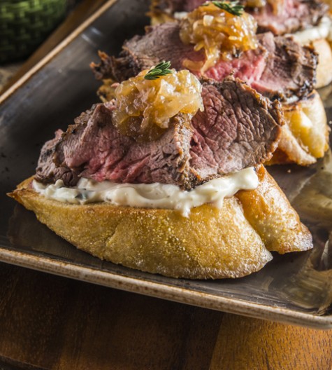 Holiday Steak Bruschetta made with beef loin, baguette, and a seasonal thyme mayonnaisse with caramelized onions . Great Thanksgiving or Christmas day appetizer.