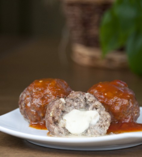 Delicious ground beef Italian meatballs served with pasta and sauce will be a hit with your family and dinner guests when they discover the hidden pocket of melted cheese inside.