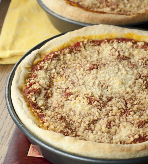 Authentic recipe for Chicago-Style Deep Dish Pizza made just like you would have in Chicago with a thick, buttery crust, homemade tomato sauce, and loaded with cheese!