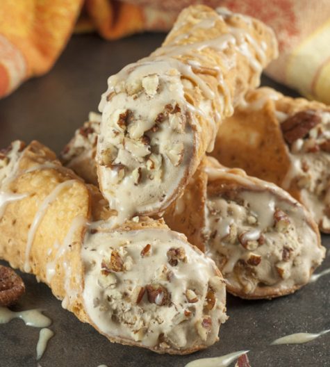 Pumpkin Spice Ice Cream Stuffed Cannoli: espresso ice cream swirled with cream cheese and pumpkin spice stuffed inside tasty cannoli shells and finished off with a sprinkle of pecans and caramel drizzle. This fall and holiday Italian dessert will blow your mind!