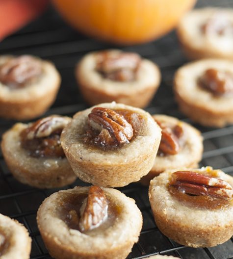 Mini Pecan Pumpkin Pies dessert recipe is all that is wonderful about the holidays rolled into one bite size treat! No need to choose between pumpkin pie or pecan pie anymore!