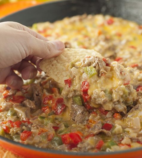 Philly Cheesesteak Dip recipe is made up of tender beef, colorful peppers, and loads of ooey gooey cheese. Perfect for game day, holidays or an appetizer to serve at a party!