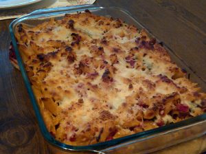 This is a baked pasta casserole dinner recipe with chicken sausage, spinach, and tomato that is restaurant quality. Delicious!