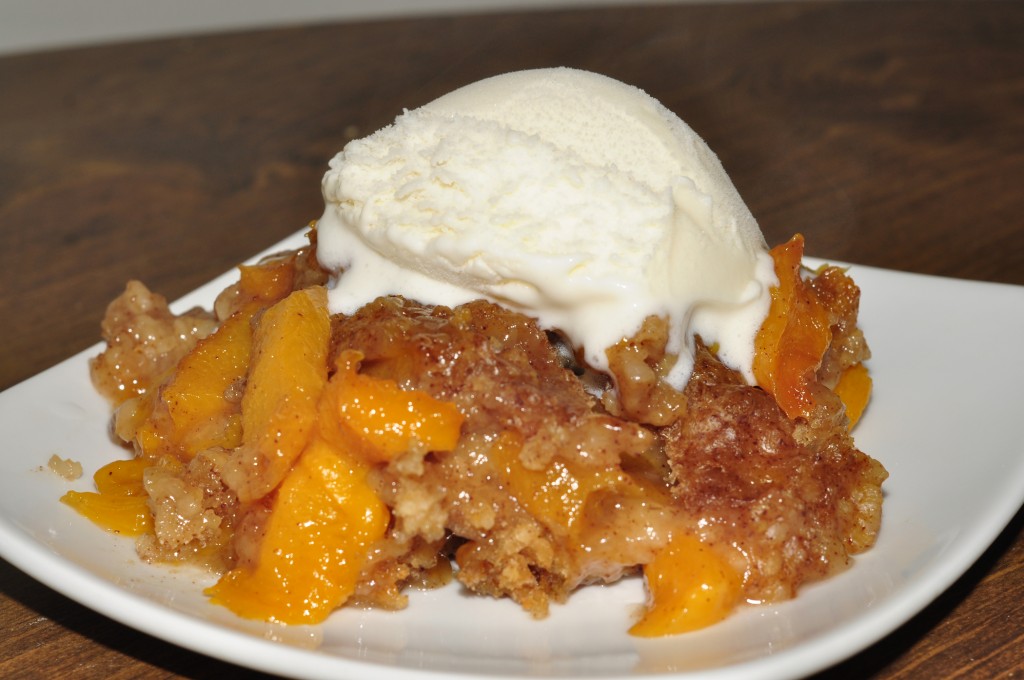 Crock Pot Slow Cooker Peach Cobbler Recipe topped with vanilla icecream