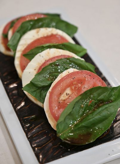 Caprese Salad with Balsamic Reduction recipe brings the flavors of fresh garden tomatoes, fresh mozzarella, and basil together for a delicious, light summer meal!