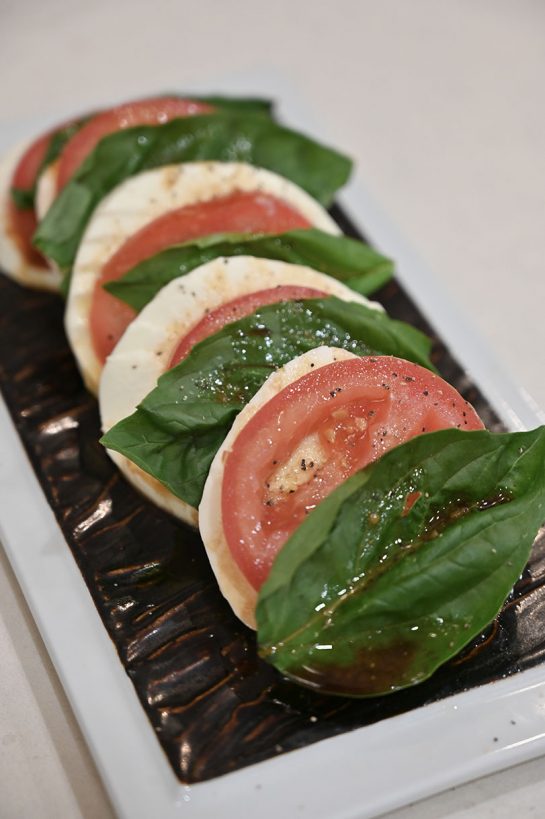 Caprese Salad with Balsamic Reduction recipe brings the flavors of fresh garden tomatoes, fresh mozzarella, and basil together for a delicious, light summer meal!