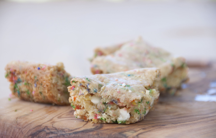 The easiest dessert recipe for soft, yet dense, cake batter blondies using cake mix, white chocolate chips, and rainbow sprinkles! Great alternative to cake for a birthday party!