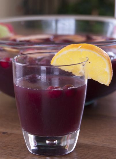 Cranberry Pomegranate sangria with orange, apples, and lemons makes a festive drink recipe to toast the winter holidays or Christmas party!