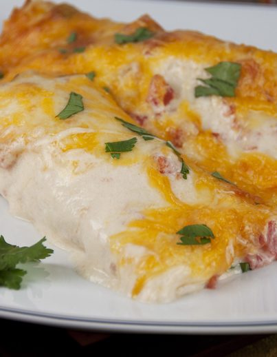The best Cheesy Sour Cream Chicken Enchiladas Recipe that are great for Mexican food night!