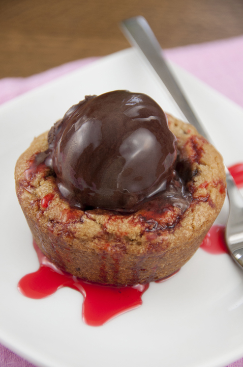 Giant Chocolate Chip Cookie Cups recipe a la mode topped with dark chocolate ice cream and finished up with a drizzle of strawberry syrup.  Great for Valentine's day.