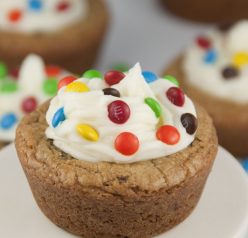 Giant Chocolate Chip Cookie Cups recipe with Almond Buttercream Icing topped with mini M&M's for a fun splash of color make for the perfect dessert for any occasion.