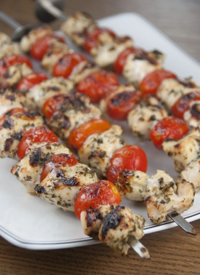Super easy, healthy restaurant-quality Grilled Pesto Chicken and Tomato Kabobs recipe for summer grilling and entertaining!