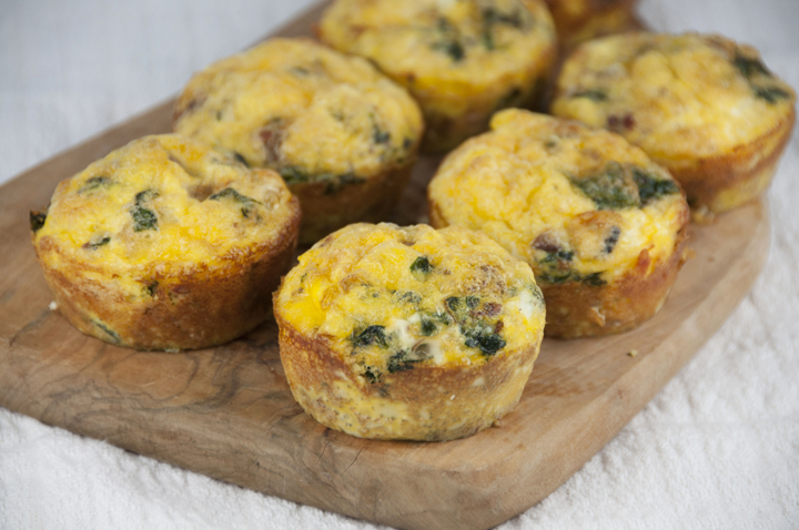 A recipe for Scrambled Egg Breakfast Muffins with sausage and green peppers or spinach that are pretty, hearty and fun to serve for breakfast or brunch.