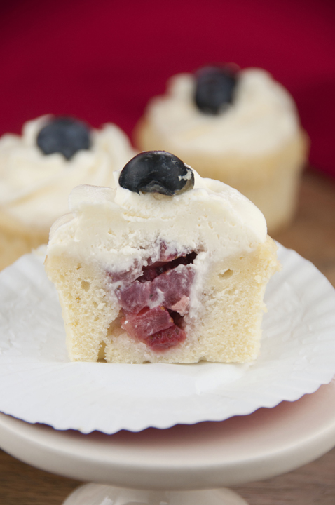 Homemade recipe for Strawberry-filled Patriotic cupcakes: Red, White and Blue pound cake cupcakes. These are topped with delicious, sturdy whipped cream cheese icing and perfect for Memorial Day or 4th of July!