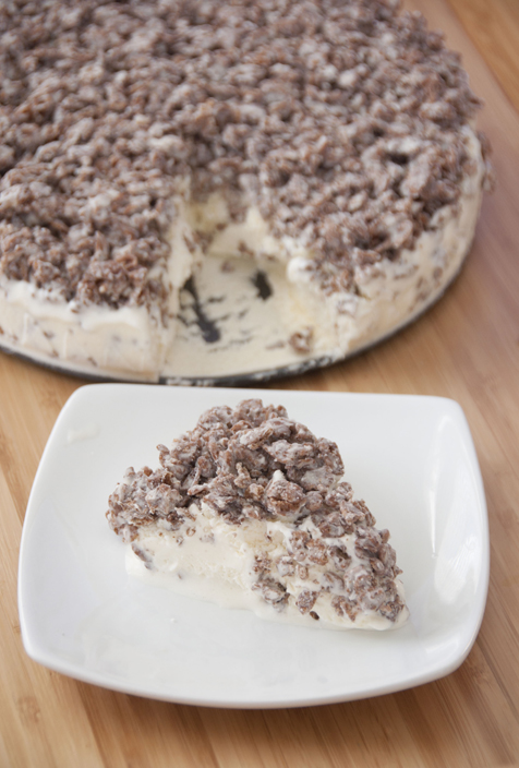 Cocoa Pebbles Ice Cream Cake is a quick and easy dessert recipe incorporating your favorite kid cereal with vanilla ice cream and melted white chocolate.