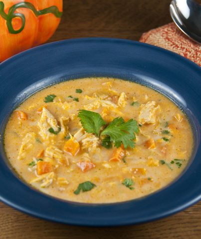 This easy pumpkin soup is made with chicken, pumpkin puree, chicken stock, and fresh vegetables Cream and cheese are stirred in at the end for added richness. The perfect fall soup!