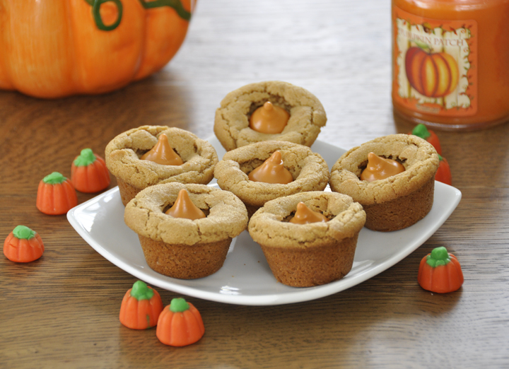 These peanut butter cookie cups are super fun with pumpkin spice Hershey's Kisses added to them. Perfect dessert for Thanksgiving, Halloween, Christmas or just because!