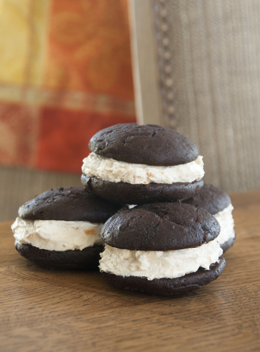 Two saucer-shaped rounds of soft chocolate cake sandwiched around a sweet orange marmalade marshmallow cream filling for a classic whoopie pie.