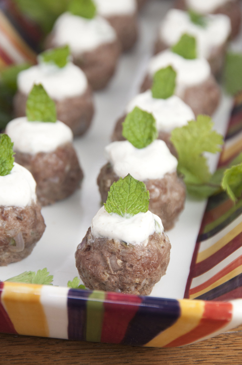 These lamb meatballs are spiced up with cumin, cilantro and mint and served with a traditional Greek yogurt sauce. Makes for a fancy appetizer for a cocktail party.