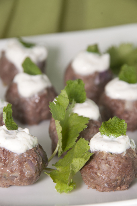 Natural lamb meatballs are spiced up with cumin, cilantro and mint and served with a traditional Greek yogurt sauce. Makes for a fancy appetizer or main course.