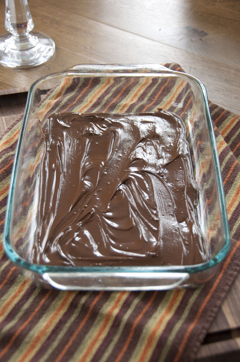 Adding the first layer to the fudge: the melted chocolate layer.