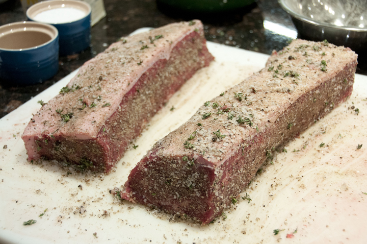 After splitting in two and rubbing the split strip beef loin roast with the garlic-herb rub.