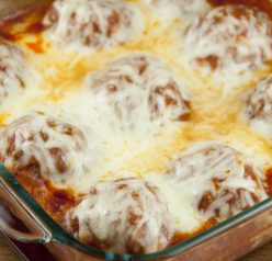 Cheesy meatballs with tomato sauce baked right in the oven - no mess or frying! Good enough for a fancy dinner to serve for a holiday or to dinner guests.