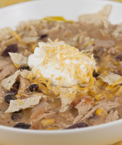 This no-fuss Chicken Tortilla Soup is quick to make, incredibly flavorful, and filling and garnished with crushed corn tortilla chips!