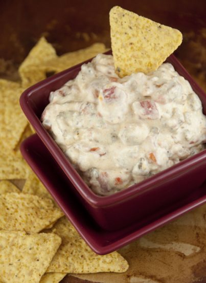 A cheese rotel dip with cooked ground sausage made with minimal ingredients and warmed up right in the crock pot makes a great appetizer for football season, holidays, pot lucks, or tailgating parties!