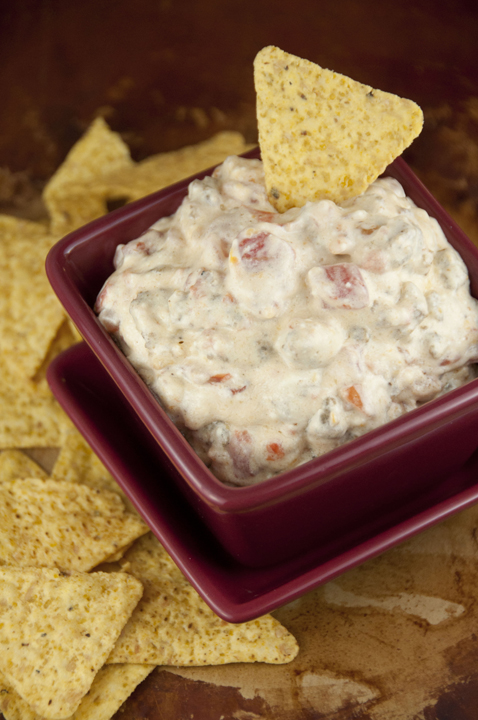 A cheese rotel dip with cooked ground sausage made with minimal ingredients and warmed up right in the crock pot makes a great appetizer for football season, holidays, pot lucks, or tailgating parties!