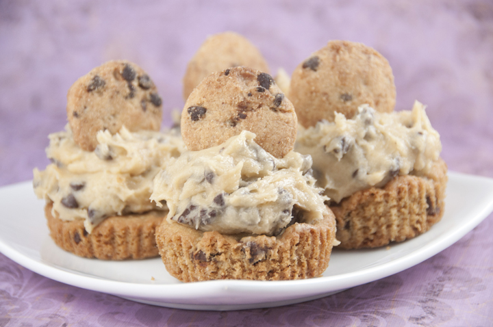 Soft, chewy ultimate chocolate dessert cookie cup recipe: thick Chocolate Chip Cookie Cups with Cookie Dough Frosting baked in a cupcake tin with rich, egg-free chocolate chip cookie dough mounded on top.