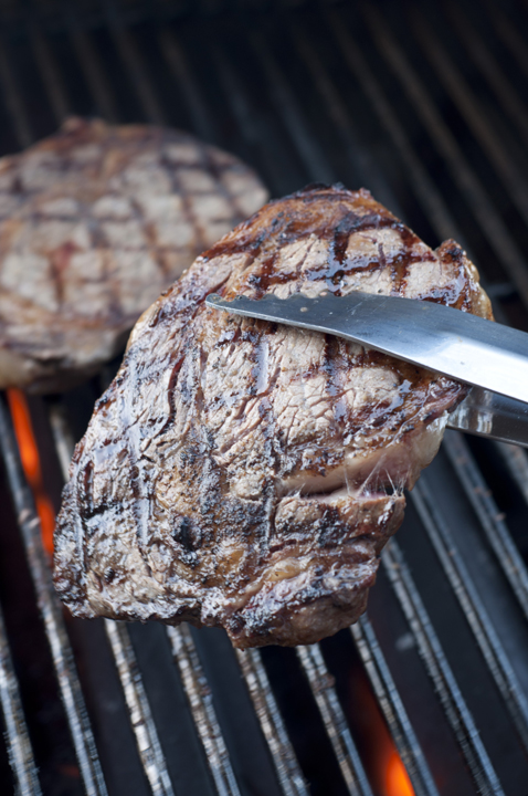 Cooking a ribeye outlet steak on the grill