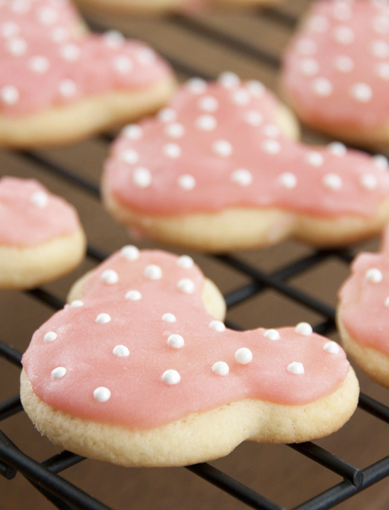 These cute Minnie Mouse sugar cookies are the easiest and the best-tasting sugar cookie recipe - great for a child's Disney themed birthday party! Frost them any way you like, but these will be your new go-to cut-out cookie!