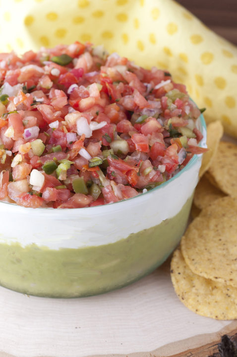 Loaded with guacamole, cheese, sour cream, and Pico de Gallo, this Triple Layer Mexican Party Dip is a fun way to enjoy your next Mexican food night!