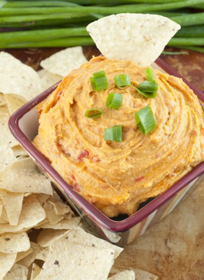 Easy Creamy Red Pepper Cashew Dip recipe is meat and dairy-free, served hot OR cold, and will be a huge hit for your next tailgate or football party this season!