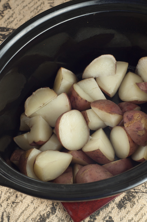 Red potatoes in the crock pot ready to be made into smashed potatoes.