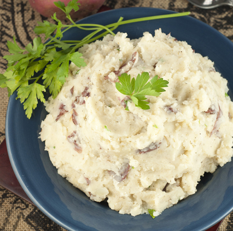 Easy recipe for herb Slow Cooker Buttery Garlic Mashed Potatoes making for an easy, stress-free side dish for Thanksgiving or holidays.