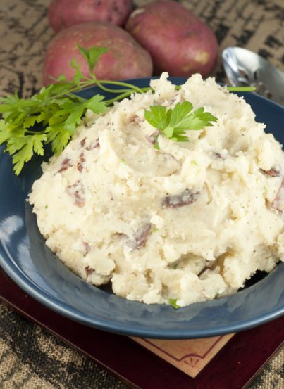 A hands-off recipe for herb Slow Cooker Buttery Garlic Mashed Potatoes making for an easy, stress-free side dish for Thanksgiving and all of the holidays.
