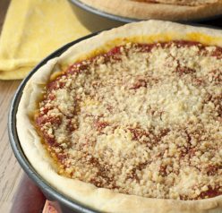 Authentic recipe for Chicago-Style Deep Dish Pizza made just like you would have in Chicago with a thick, buttery crust, homemade tomato sauce, and loaded with cheese!