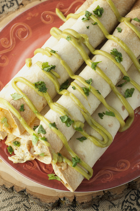 Quick and easy recipe for Crock Pot Creamy Salsa Verde Chicken Taquitos recipe that is perfect for a main course or appetizer and drizzled with my favorite avocado spread. Great for Cinco de Mayo!