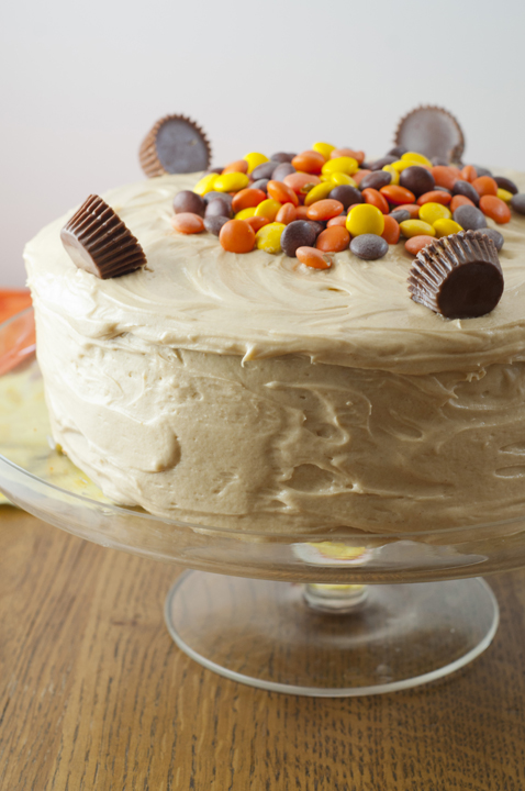 Reese's Double Peanut Butter Layer Cake on a glass cake stand