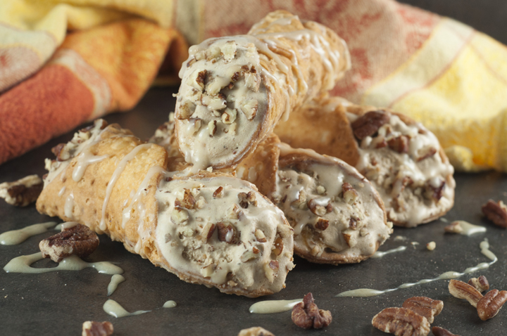Pumpkin Spice Ice Cream Cannoli: espresso ice cream swirled with cream cheese and pumpkin puree chunks stuffed inside tasty cannoli shells and finished off with a sprinkle of pecans and caramel drizzle. This fall and holiday Italian dessert will blow you away!