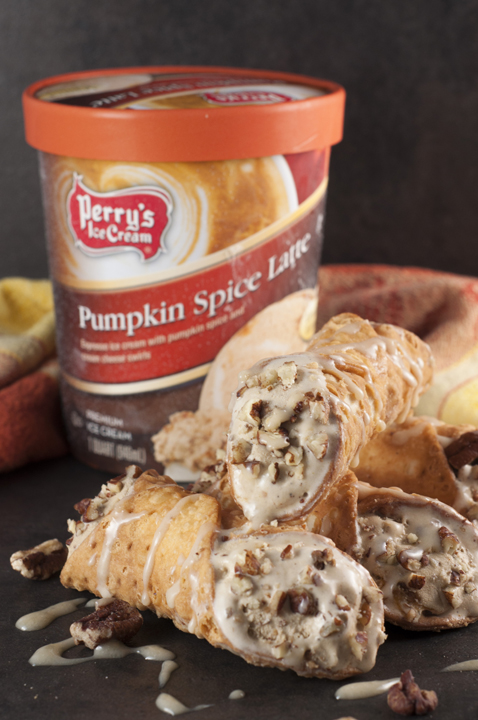 Pumpkin Spice Ice Cream Cannoli: espresso ice cream swirled with cream cheese and pumpkin spice stuffed inside tasty cannoli shells and finished off with a sprinkle of pecans and caramel drizzle. This fall and holiday Italian dessert will blow you away!
