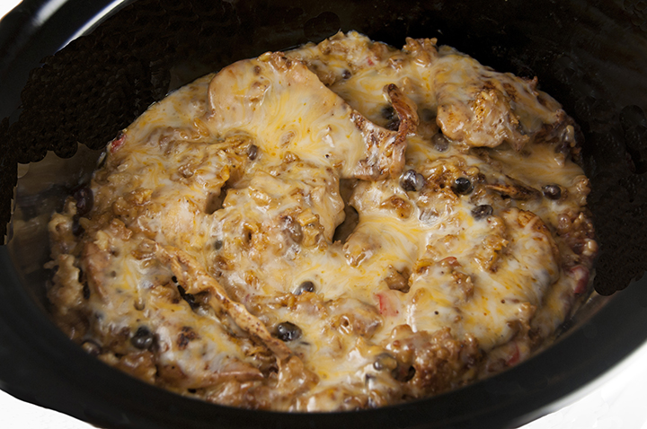 Slow Cooker Fiesta Mexican Chicken & Rice recipe is an easy, creamy, cheesy chicken dish. Throw everything in your crock pot and have a hot, homemade supper on the table in no time at all!