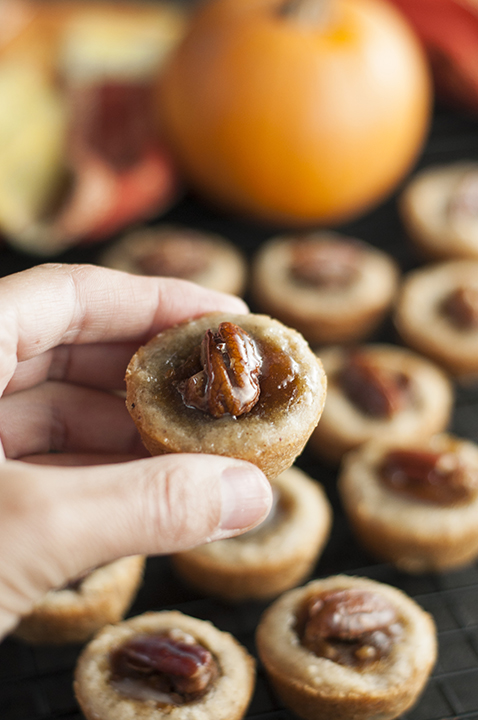 Mini Pecan Pumpkin Pies Thanksgiving dessert recipe is all that is wonderful about the holidays rolled into one bite size treat! No need to choose between pumpkin pie or pecan pie anymore!