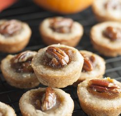 Mini Pecan Pumpkin Pies dessert recipe is all that is wonderful about the holidays rolled into one bite size treat! No need to choose between pumpkin pie or pecan pie anymore!