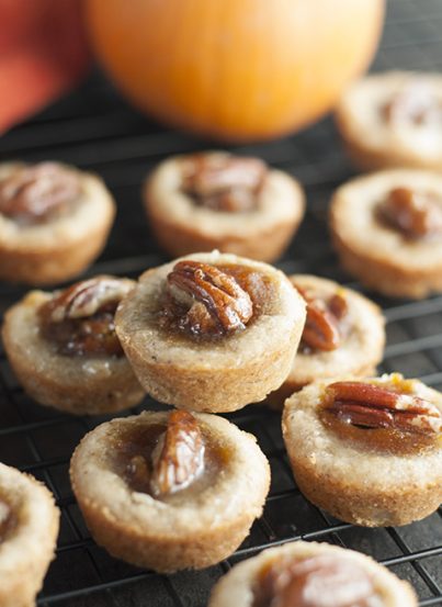 Mini Pecan Pumpkin Pies dessert recipe is all that is wonderful about the holidays rolled into one bite size treat! No need to choose between pumpkin pie or pecan pie anymore!