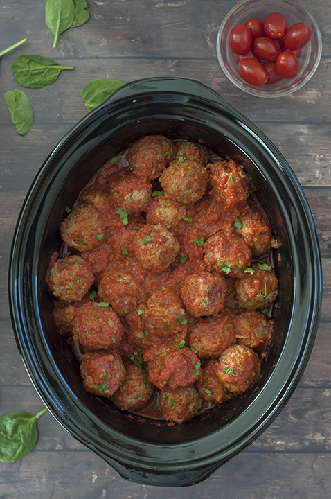 Easy Slow Cooker Italian Meatballs packed with Parmesan cheese, fresh parsley and garlic in a delicious marinara sauce! They work well for a main course served over pasta, a holiday party or a potluck!