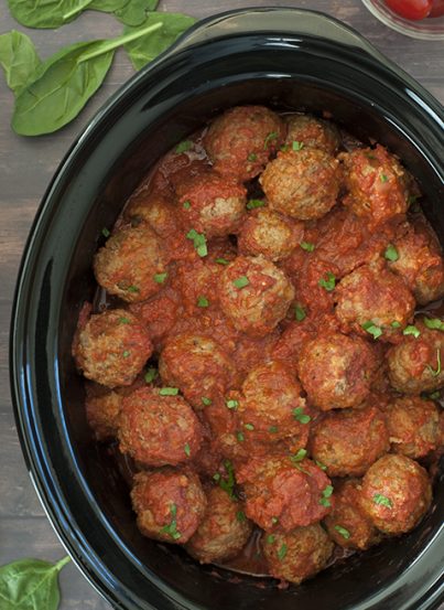 Quick and Easy Slow Cooker/Crock Pot Italian Meatballs packed with Parmesan cheese, fresh parsley and garlic in a delicious marinara sauce! They work well for dinner served over pasta, a holiday party or a potluck!