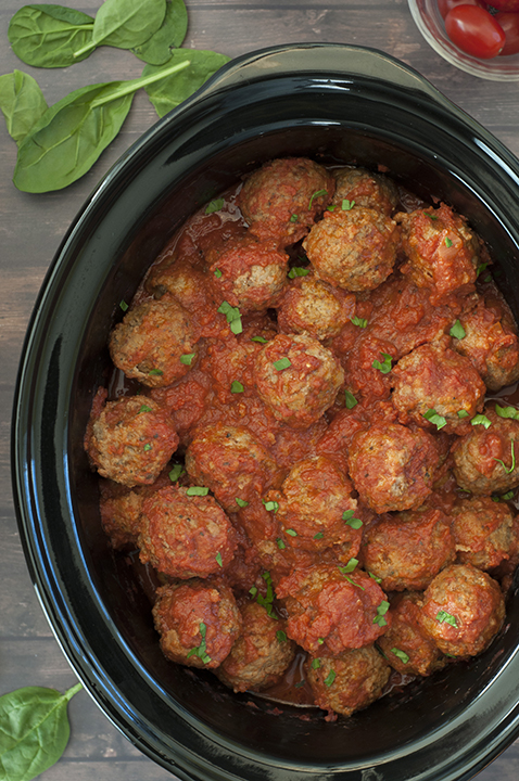Quick and Easy Slow Cooker/Crock Pot Italian Meatballs packed with Parmesan cheese, fresh parsley and garlic in a delicious marinara sauce! They work well for dinner served over pasta, a holiday party appetizer or a potluck!